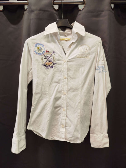 Camicia La Martina size S, white shirt with embroidery, in excellent condition, hanging on a display.
